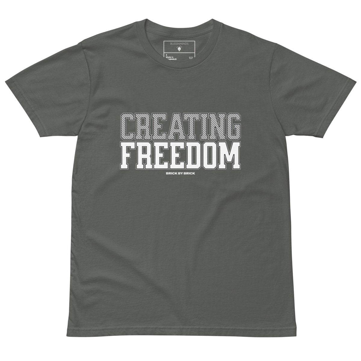 Charcoal Green tee with bold gray and white text “Creating Freedom” and small “Brick by Brick” centered below