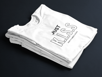 White folded t-shirt with bold black text “JUST K.I.S.S” and smaller text “Keep It Simple, Stupid” centered on the front.