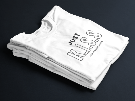 White folded t-shirt with bold black text “JUST K.I.S.S” and smaller text “Keep It Simple, Stupid” centered on the front.