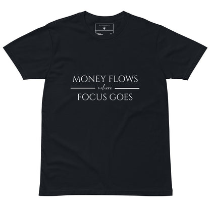 Navy tee with white text “Money Flows Where Focus Goes” in elegant serif font, with horizontal lines next to “where"