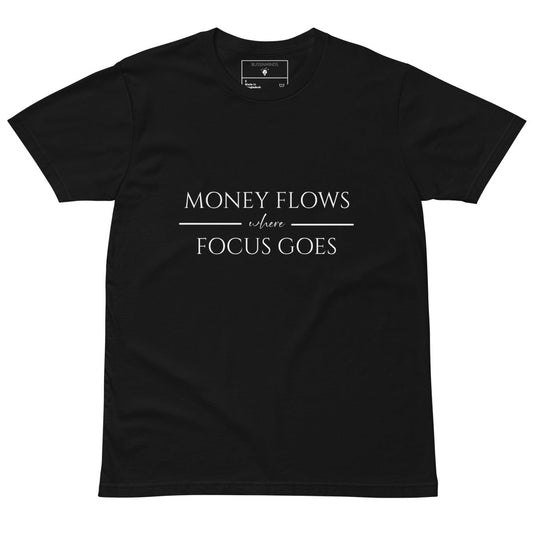 Black tee with white text “Money Flows Where Focus Goes” in elegant serif font, with horizontal lines next to “where"