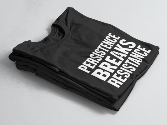 Black folded t-shirt with bold white text “Persistence Breaks Resistance” and a lightning bolt in the letter “A” of BREAKS.