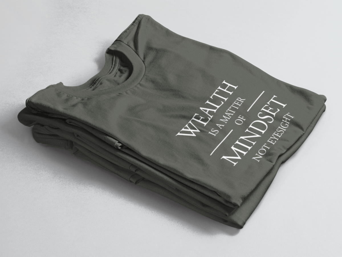 Charcoal folded tee with white text “Wealth is a Matter of Mindset, Not Eyesight” in elegant serif font with horizontal lines.